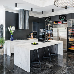 Design ideas for a mid-sized contemporary l-shaped open plan kitchen in Melbourne with a double-bowl sink, flat-panel cabinets, black cabinets, marble benchtops, black splashback, stone slab splashback, stainless steel appliances, marble floors, with island, black floor and white benchtop.