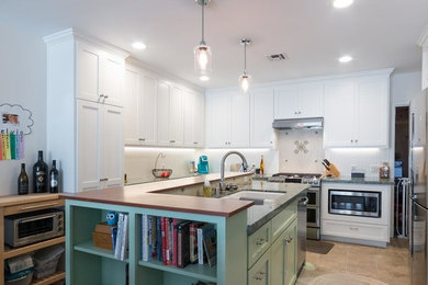 Mid-sized transitional u-shaped ceramic tile and beige floor kitchen photo in Los Angeles with a double-bowl sink, shaker cabinets, white cabinets, quartzite countertops, white backsplash, ceramic backsplash, stainless steel appliances and an island