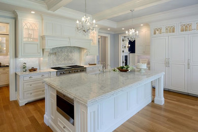 Enclosed kitchen - large shabby-chic style l-shaped light wood floor and brown floor enclosed kitchen idea in Boston with a farmhouse sink, beaded inset cabinets, white cabinets, marble countertops, gray backsplash, mosaic tile backsplash, paneled appliances and an island