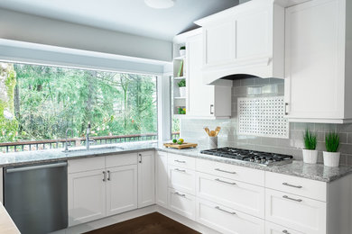 Eat-in kitchen - large contemporary u-shaped medium tone wood floor and brown floor eat-in kitchen idea in Portland with an undermount sink, recessed-panel cabinets, white cabinets, wood countertops, gray backsplash, ceramic backsplash, stainless steel appliances and an island