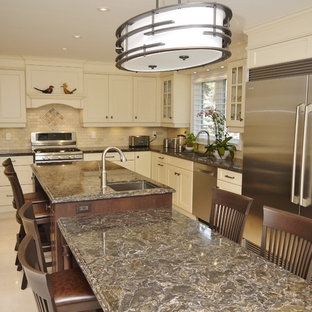 Mid-sized traditional l-shaped separate kitchen in Toronto with an undermount sink, recessed-panel cabinets, yellow cabinets, quartz benchtops, beige splashback, stone tile splashback, stainless steel appliances, porcelain floors and with island.