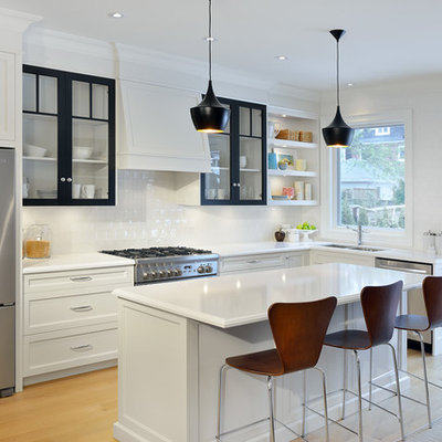 Kitchen - mid-sized traditional l-shaped light wood floor kitchen idea in Toronto with an undermount sink, recessed-panel cabinets, quartz countertops, white backsplash, porcelain backsplash, stainless steel appliances and an island
