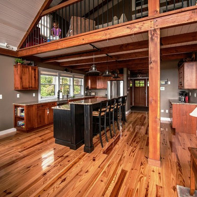 Large mountain style l-shaped light wood floor eat-in kitchen photo in Portland Maine with an undermount sink, flat-panel cabinets, medium tone wood cabinets, granite countertops, stainless steel appliances and an island