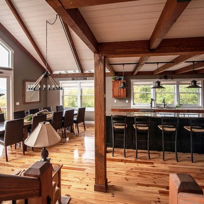 Example of a large mountain style l-shaped light wood floor eat-in kitchen design in Portland Maine with an undermount sink, flat-panel cabinets, medium tone wood cabinets, granite countertops, stainless steel appliances and an island