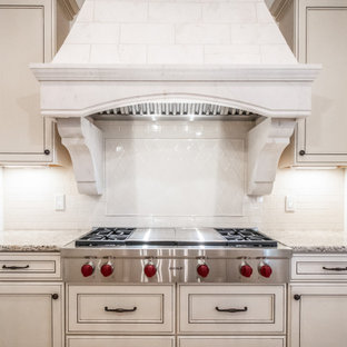 Large french country eat-in kitchen ideas - Large french country eat-in kitchen photo in Cleveland with a double-bowl sink, beige cabinets, beige backsplash, stainless steel appliances and multicolored countertops