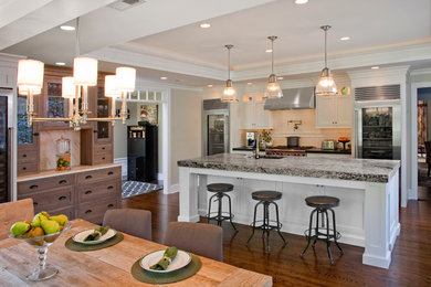 Eat-in kitchen - traditional galley eat-in kitchen idea in Philadelphia with white cabinets and stainless steel appliances