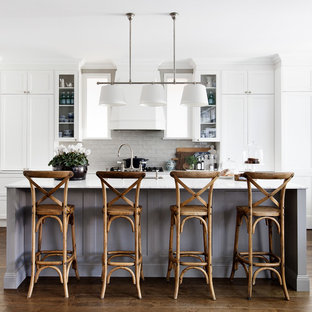 Transitional galley eat-in kitchen in Sydney with recessed-panel cabinets, white cabinets, dark hardwood floors, with island, brown floor, an undermount sink, subway tile splashback, white appliances and white benchtop.