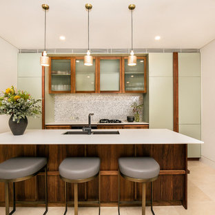 Design ideas for a mid-sized contemporary kitchen in Sydney with a double-bowl sink, glass-front cabinets, with island, beige floor and white benchtop.
