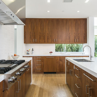 Foto di una cucina moderna di medie dimensioni con lavello a doppia vasca, pavimento in legno massello medio, isola, ante lisce, ante in legno bruno, top in quarzo composito, paraspruzzi bianco, paraspruzzi con piastrelle in ceramica, elettrodomestici in acciaio inossidabile e pavimento beige