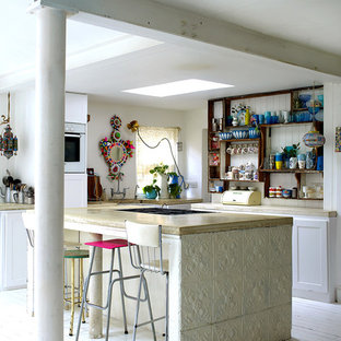 Shabby-chic style l-shaped kitchen in London with open cabinets, dark wood cabinets, white appliances, painted wood floors and with island.