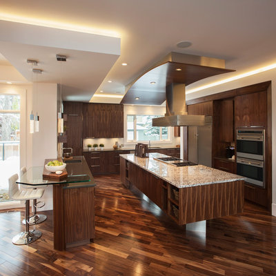 Inspiration for a contemporary brown floor kitchen remodel in Calgary with stainless steel appliances, flat-panel cabinets and dark wood cabinets