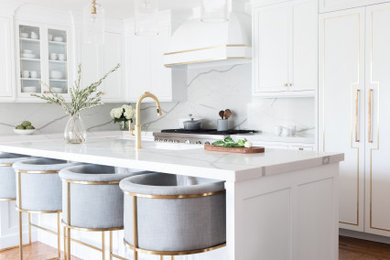 Kitchen - large transitional l-shaped medium tone wood floor and beige floor kitchen idea in New York with an undermount sink, shaker cabinets, white cabinets, white backsplash, paneled appliances, an island and white countertops