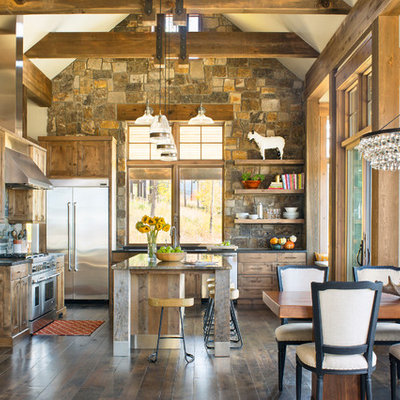 Inspiration for a rustic l-shaped dark wood floor and brown floor eat-in kitchen remodel in Denver with recessed-panel cabinets, medium tone wood cabinets, gray backsplash, stone tile backsplash, stainless steel appliances, an island and black countertops