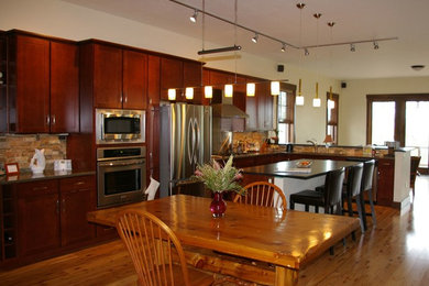 Inspiration for a rustic l-shaped light wood floor eat-in kitchen remodel in Denver with an undermount sink, multicolored backsplash, stone tile backsplash, stainless steel appliances and an island