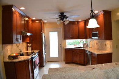 Mid-sized transitional u-shaped eat-in kitchen photo in Boston with an undermount sink, shaker cabinets, medium tone wood cabinets, granite countertops and stainless steel appliances