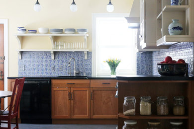 Example of a mid-sized classic l-shaped eat-in kitchen design in Philadelphia with an integrated sink, glass-front cabinets, medium tone wood cabinets, multicolored backsplash, ceramic backsplash and stainless steel appliances
