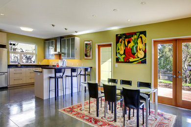 Photo of a medium sized traditional u-shaped kitchen/diner in Seattle with glass-front cabinets, onyx worktops, green splashback, stainless steel appliances and a breakfast bar.