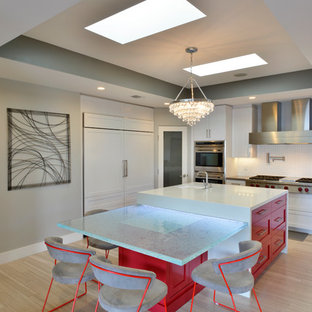 Contemporary kitchen designs - Inspiration for a contemporary u-shaped light wood floor kitchen remodel in San Diego with shaker cabinets, white cabinets, white backsplash, mosaic tile backsplash, stainless steel appliances and an island