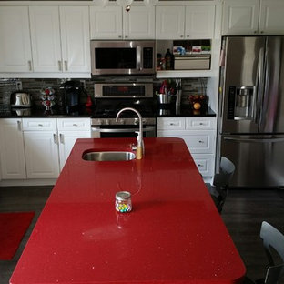 Inspiration for a mid-sized contemporary l-shaped eat-in kitchen in Toronto with an undermount sink, shaker cabinets, white cabinets, quartz benchtops, multi-coloured splashback, matchstick tile splashback, stainless steel appliances, porcelain floors, with island and red benchtop.