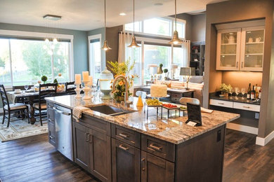 Large trendy l-shaped dark wood floor open concept kitchen photo in Other with shaker cabinets, an island, white cabinets, granite countertops, an undermount sink, gray backsplash, glass tile backsplash and stainless steel appliances