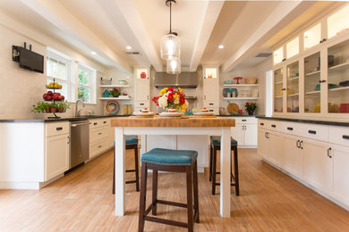 Example of a mid-sized arts and crafts u-shaped ceramic tile and brown floor kitchen pantry design in Phoenix with a double-bowl sink, shaker cabinets, white cabinets, wood countertops, white backsplash, subway tile backsplash, stainless steel appliances and an island