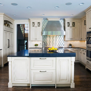 Multi-level center island with full height metal backsplash behind range