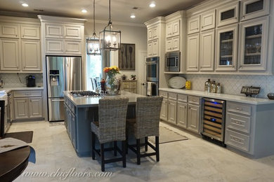 Transitional u-shaped porcelain tile eat-in kitchen photo in Houston with a farmhouse sink, raised-panel cabinets, gray cabinets, quartz countertops, white backsplash, porcelain backsplash, stainless steel appliances and an island