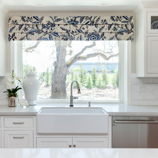 Photo of a mid-sized traditional single-wall eat-in kitchen in Sacramento with a farmhouse sink, beaded inset cabinets, white cabinets, quartz benchtops, white splashback, ceramic splashback, stainless steel appliances, medium hardwood floors, with island, yellow floor and white benchtop.
