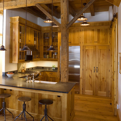 Example of a mountain style u-shaped open concept kitchen design in Burlington with a farmhouse sink, medium tone wood cabinets, stainless steel appliances and shaker cabinets
