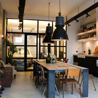 Example of an eclectic single-wall eat-in kitchen design in Amsterdam with a farmhouse sink, open cabinets, white cabinets, white backsplash, subway tile backsplash and black appliances
