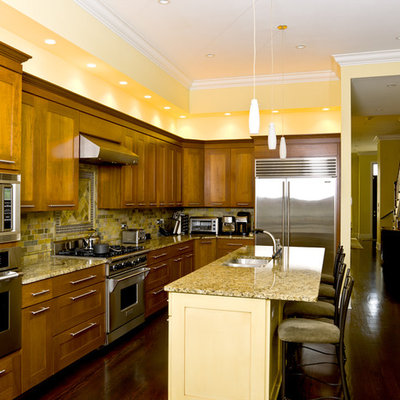 Example of a classic kitchen design in Chicago with stainless steel appliances and slate backsplash