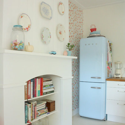 Kitchen - shabby-chic style kitchen idea in Amsterdam with white cabinets, wood countertops and colored appliances
