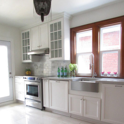 Kitchen - traditional white floor kitchen idea in Toronto with a farmhouse sink, recessed-panel cabinets, white cabinets and stainless steel appliances