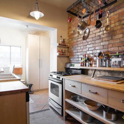 Enclosed kitchen - eclectic galley enclosed kitchen idea in Salt Lake City with a double-bowl sink, open cabinets, medium tone wood cabinets, wood countertops, mosaic tile backsplash and stainless steel appliances