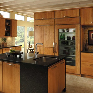 Photo of a large midcentury single-wall separate kitchen in Atlanta with an undermount sink, flat-panel cabinets, medium wood cabinets, quartz benchtops, multi-coloured splashback, mosaic tile splashback, stainless steel appliances, travertine floors, with island, beige floor and black benchtop.