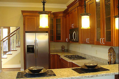 Example of a kitchen design in Other with granite countertops and stainless steel appliances
