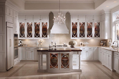 Inspiration for a mid-sized timeless u-shaped beige floor kitchen remodel in Other with a double-bowl sink, raised-panel cabinets, white cabinets, wood countertops, beige backsplash and an island