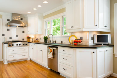 Inspiration for a transitional single-wall light wood floor eat-in kitchen remodel in Atlanta with an undermount sink, recessed-panel cabinets, white cabinets, white backsplash, ceramic backsplash, stainless steel appliances and no island