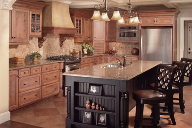 Mid-sized transitional l-shaped beige floor eat-in kitchen photo in Cleveland with recessed-panel cabinets, medium tone wood cabinets, granite countertops, beige backsplash, ceramic backsplash, stainless steel appliances, an island and an undermount sink