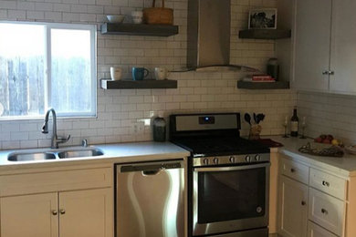 Transitional kitchen photo in Other with a double-bowl sink, shaker cabinets, white cabinets, white backsplash, subway tile backsplash, stainless steel appliances and white countertops