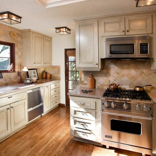 Mediterranean enclosed kitchen designs - Tuscan enclosed kitchen photo in San Diego with an undermount sink, recessed-panel cabinets, beige cabinets, beige backsplash and stainless steel appliances