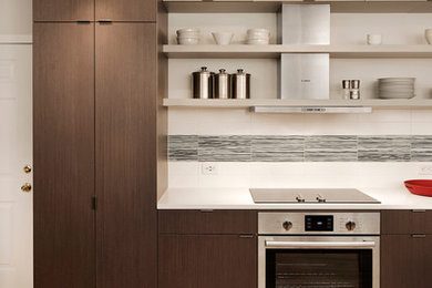 Minimalist single-wall medium tone wood floor eat-in kitchen photo in DC Metro with a drop-in sink, flat-panel cabinets, medium tone wood cabinets, stainless steel appliances, no island, quartz countertops, multicolored backsplash and porcelain backsplash