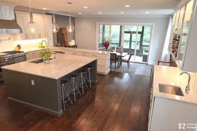 Large trendy dark wood floor eat-in kitchen photo in Atlanta with a single-bowl sink, shaker cabinets, white cabinets, marble countertops, white backsplash, subway tile backsplash, stainless steel appliances and an island