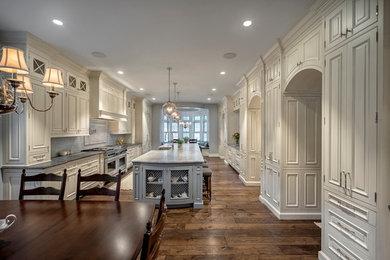 Inspiration for a large timeless eat-in kitchen remodel in Chicago with raised-panel cabinets, white cabinets and an island