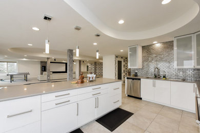 Large elegant u-shaped porcelain tile and beige floor eat-in kitchen photo in Chicago with an undermount sink, glass-front cabinets, white cabinets, quartz countertops, gray backsplash, ceramic backsplash, stainless steel appliances, an island and gray countertops