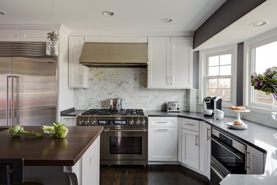 Eat-in kitchen - large transitional dark wood floor eat-in kitchen idea in Chicago with a single-bowl sink, shaker cabinets, white cabinets, quartz countertops, white backsplash, stone tile backsplash, stainless steel appliances and two islands