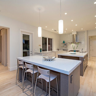 Design ideas for a large transitional u-shaped eat-in kitchen in Miami with an undermount sink, flat-panel cabinets, grey cabinets, quartz benchtops, white splashback, porcelain floors, multiple islands and stainless steel appliances.