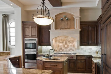 Large tuscan kitchen photo in Detroit with raised-panel cabinets, brown cabinets, granite countertops, beige backsplash, stone tile backsplash, stainless steel appliances and two islands