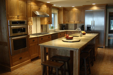 Enclosed kitchen - mid-sized contemporary l-shaped ceramic tile enclosed kitchen idea in Portland Maine with an undermount sink, beaded inset cabinets, medium tone wood cabinets, granite countertops, multicolored backsplash, ceramic backsplash, stainless steel appliances and an island