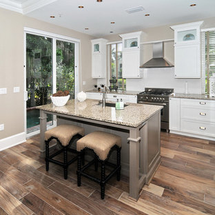 Inspiration for a timeless kitchen remodel in Miami with stainless steel appliances and white backsplash